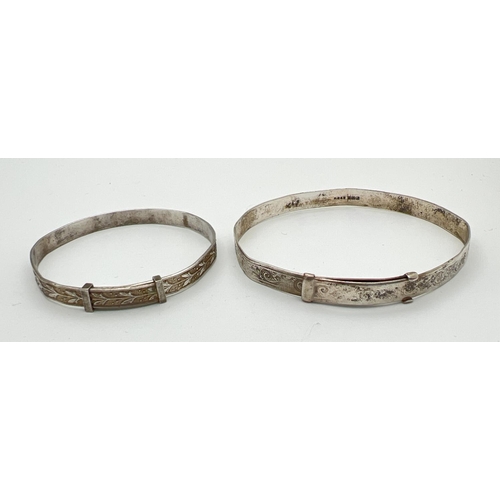 50 - 2 vintage silver expanding bangles, both with floral engraved detail throughout (both miss-shaped). ... 