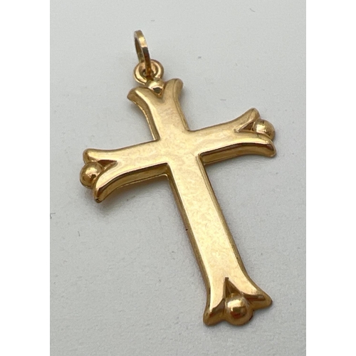 52 - A 9ct gold cross shaped pendant with ball detail to each point. Bale marked 375. Approx. 3.5cm x 2cm... 