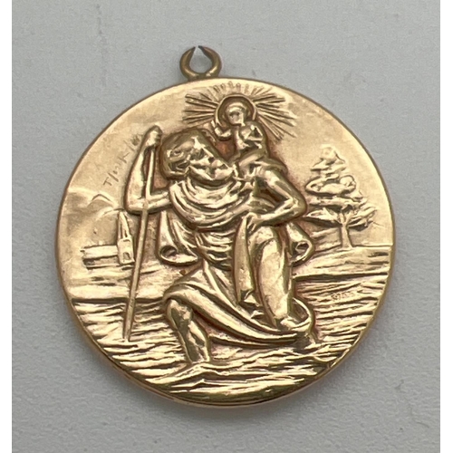 61 - A vintage 9ct gold St. Christopher pendant with train, plane, car and ship detail to back. Fully hal... 