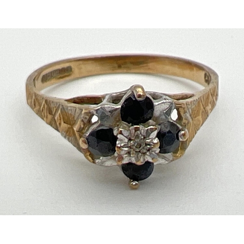 71 - A vintage 9ct gold sapphire and diamond dress ring. A small central round cut diamond surrounded by ... 