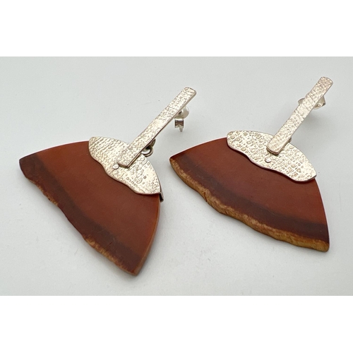 76 - A pair of contemporary style drop silver and resin earrings. Semi circle shaped brown resin pieces c... 