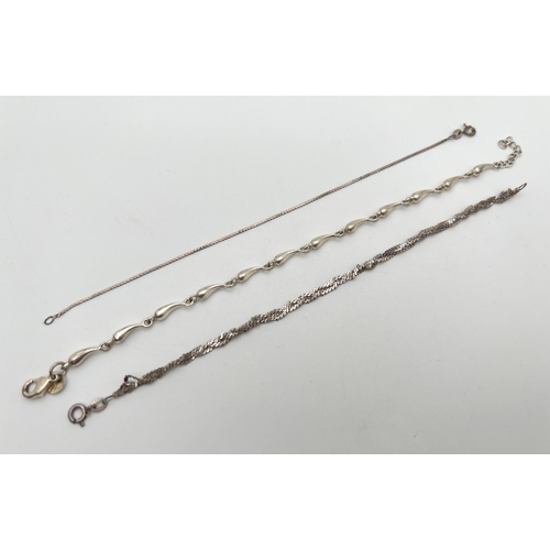 77 - 3 silver chain bracelets. A teardrop shaped link bracelet with lobster claw clasp; a plaited serpent... 