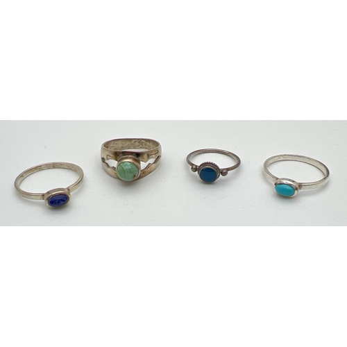 78 - 4 silver dress rings each set with a single cabochon stone. To include Turquoise and Lapis Lazuli. S... 