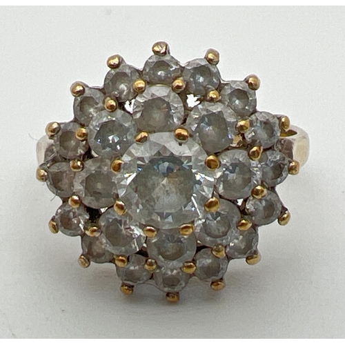 85 - A 9ct gold and cubic zirconia large cluster ring. Central round cut stone surrounded by 2 rows of sm... 