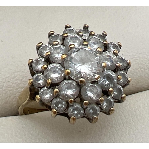 85 - A 9ct gold and cubic zirconia large cluster ring. Central round cut stone surrounded by 2 rows of sm... 