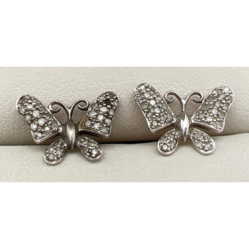 97 - A pair of 9ct white gold butterfly stud style earrings. Each set with 33 small round cut diamonds (o... 