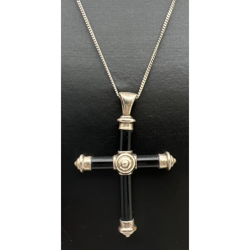 109 - A black onyx and silver cross pendant on a 19 inch fine curb chain with spring clasp. Silver marks t... 