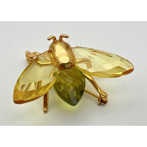 115 - A boxed Swarovski Crystal flying insect brooch from the 'Paradise Bugs' range. Gold plated silver wi... 