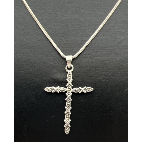 116 - A silver cross shaped pendant set with marcasite stones, on a 17