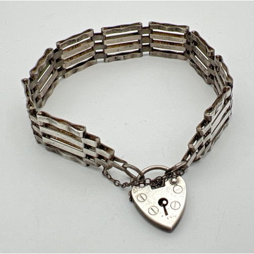 121 - A vintage silver 4 bar gate bracelet with padlock and safety chain. Hallmarked for London 1977. Tota... 