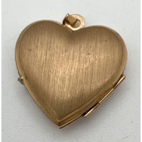 125 - A 9ct gold heart shaped locket with floral engraved detail to front and brushed gold design to back.... 