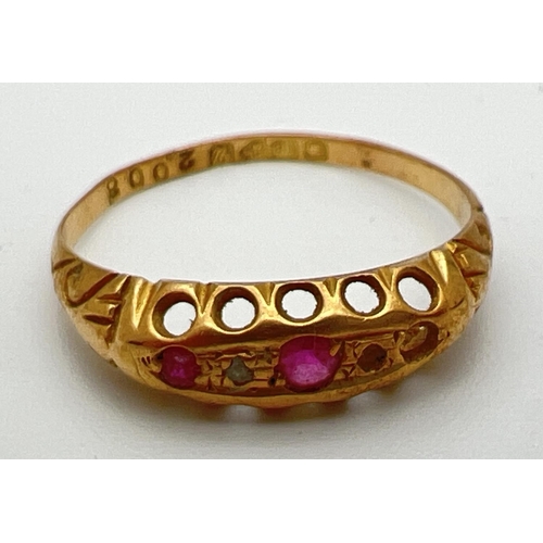 165 - A vintage 18ct gold ruby and diamond gypsy style ring with scroll decoration to shoulders. One small... 