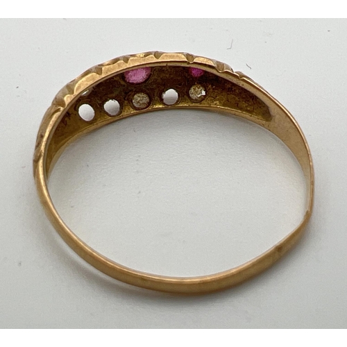 165 - A vintage 18ct gold ruby and diamond gypsy style ring with scroll decoration to shoulders. One small... 