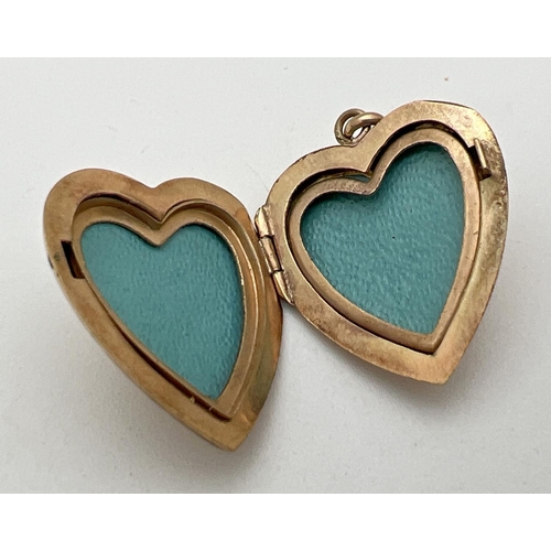 175 - A vintage 9ct gold heart shaped locket with front floral & scroll engraved decoration. Inscription a... 