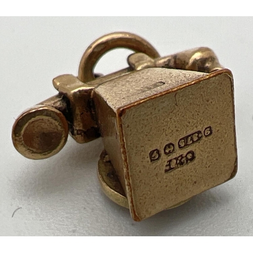 180 - A 9ct gold pendant/charm modelled as a telephone with enamel detail to dial. Gold marks to base and ... 