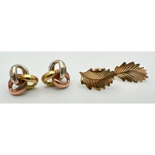 184 - 2 pairs of yellow metal stud earrings. A pair of tri coloured gold knots and a pair of leaf design s... 