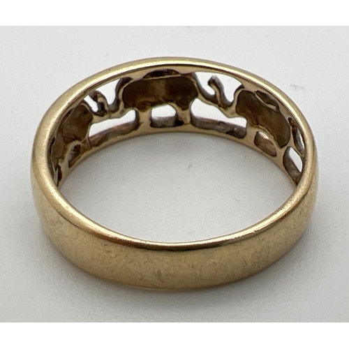 187 - A 9ct white and yellow gold pierced work elephant band ring. Full hallmarks to inside of band. Size ... 