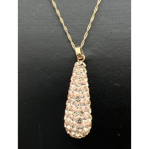 192 - A teardrop shaped pendant set with champagne coloured crystals and a 9ct gold bale. On an 18