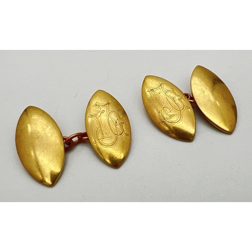 196 - A pair of 18ct gold marquise shaped cufflinks with engraved initials J I G to each. Marked 18ct to b... 