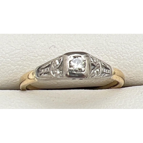 200 - An Art Deco 18ct gold and platinum 0.05ct diamond solitaire ring with leaf pattern to shoulders. Gol... 