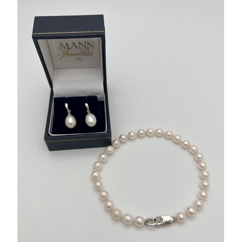 201 - 2 items of silver and freshwater pearl jewellery. A pair of boxed drop style white pearl earrings, t... 