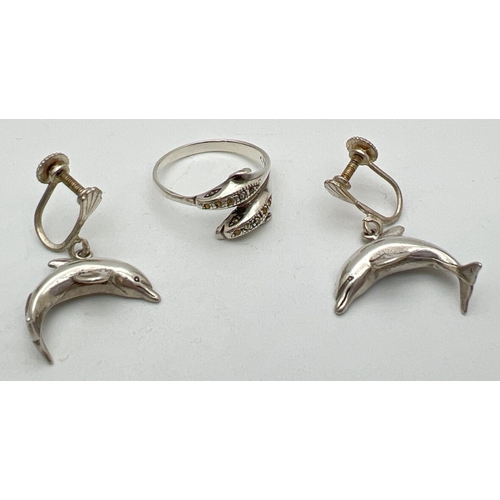 213 - A pair of silver dolphin drop style earrings with screw backs, together with a double dolphin ring s... 