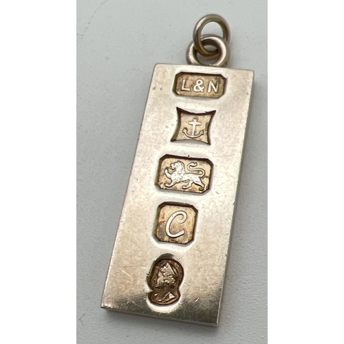 215 - A Jubilee silver ingot pendant with hanging bale hallmarked to front for Birmingham 1977, with Queen... 