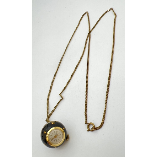 221 - A vintage ball pendant watch by Buler. Gold tone case set with black enamel and gold inset decoratio... 