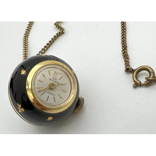 221 - A vintage ball pendant watch by Buler. Gold tone case set with black enamel and gold inset decoratio... 