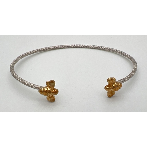 234 - A boxed 925 silver cuff style bangle with bee design finials. Honeycomb design to body of bangle wit... 