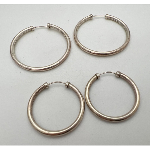 236 - 2 pairs of silver hoop earrings. Both have silver marks to posts. Largest pair approx. 4cm diameter.