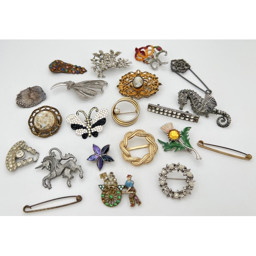 238 - 21 vintage brooches, dress clips and scarf rings in various designs and sizes. To include art Nouvea... 