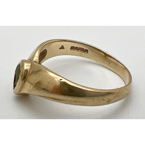 244 - A 9ct gold wishbone style yellow gold dress ring set with a teardrop cut peridot (wear to stone). Fu... 