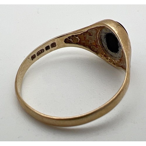 245 - A 9ct gold signet ring set with an oval of black onyx. Hallmarks to inside of band. Size O, total we... 