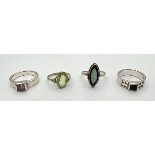 264 - 4 silver stone set dress rings to include amethyst, Onyx and mother of pearl. Sizes K, M and N.