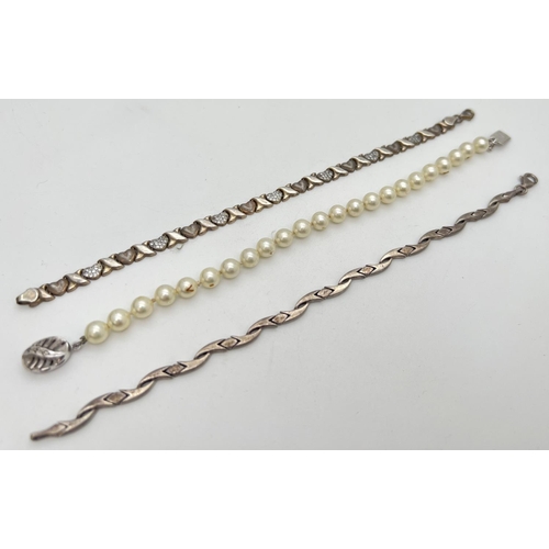 265 - 3 bracelets to include silver. A faux pearl with silver push clasp, a hearts and kisses bracelet mar... 