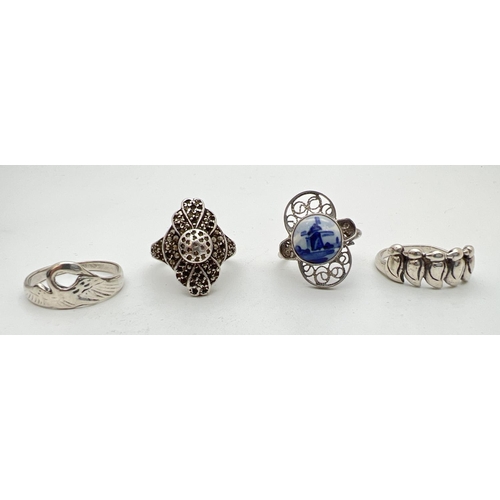 273 - 4 vintage silver rings. A filigree design ring with central delft ceramic panel, a swan ring, a flor... 