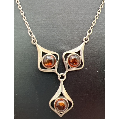 275 - A silver fixed drop pendant necklace set with 3 cabochons of cognac amber. Total length approx 18,5 ... 