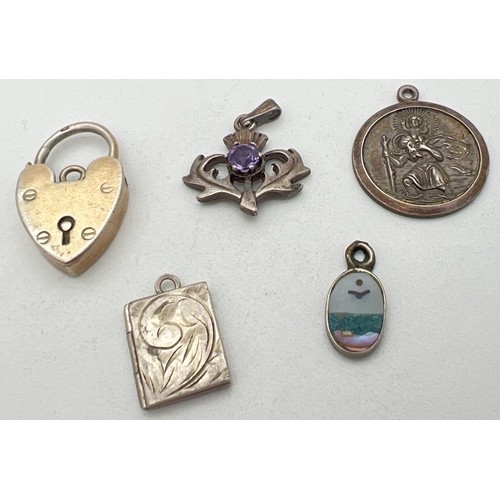 288 - 5 silver pendants/charms. To include Square shaped engraved locket, St. Christopher, Scottish thistl... 