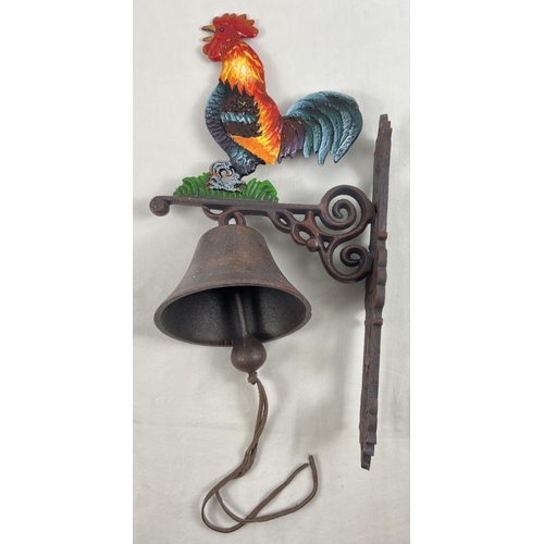 1524 - A wall mountable cast iron garden bell with painted cockerel detail and leather strap bell pull. App... 