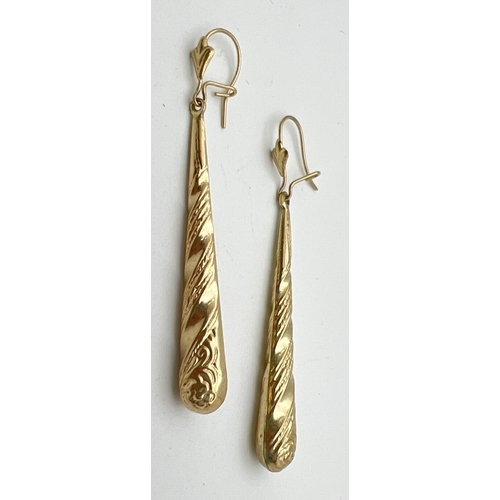 126 - A pair of unmarked gold teardrop style earrings with hooked posts. Floral and rope design to body wi... 