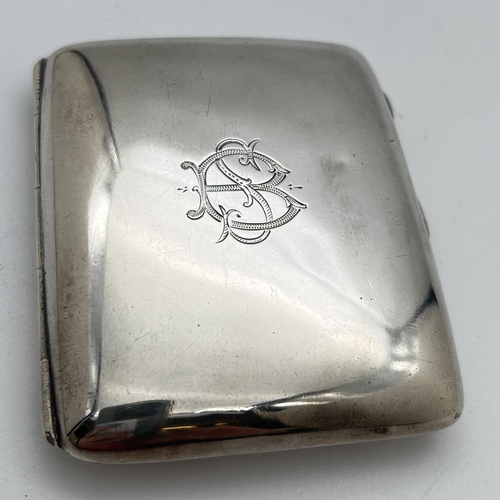 1116 - An early 20th century silver curve backed cigarette case with engraved monogram detail to front. Hal... 