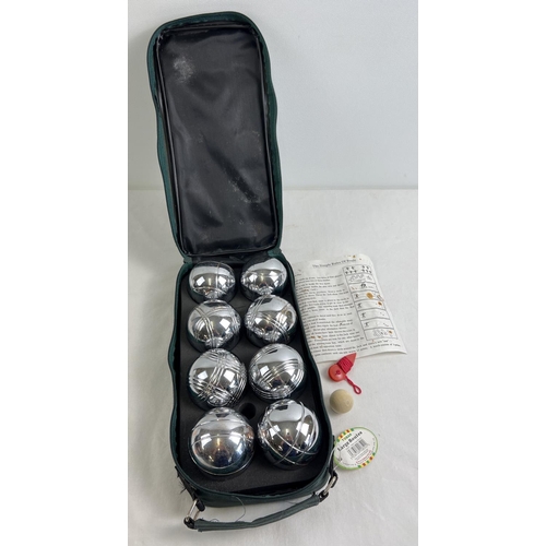 1260 - A cased set of chrome plated garden Boules, complete with instructions, marker & piglet. In a green ... 