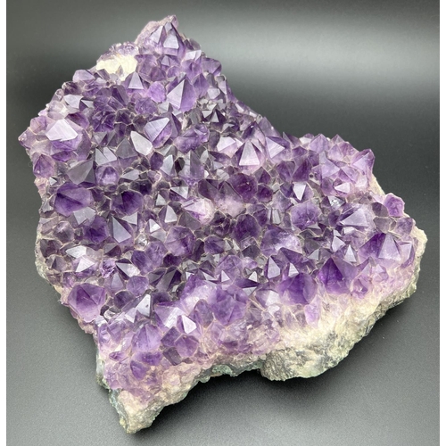 1267 - A large 3.7kg natural amethyst cluster geode with varying sized points. Approx. 23cm x 20cm at wides... 