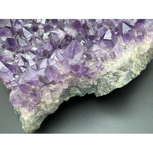 1267 - A large 3.7kg natural amethyst cluster geode with varying sized points. Approx. 23cm x 20cm at wides... 