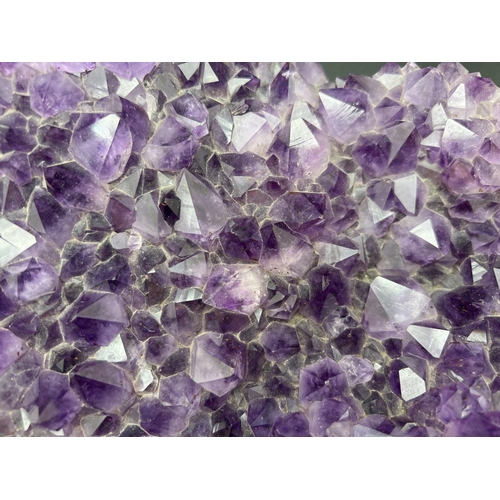 1267 - A large 3.7kg natural amethyst cluster geode with varying sized points. Approx. 23cm x 20cm at wides... 