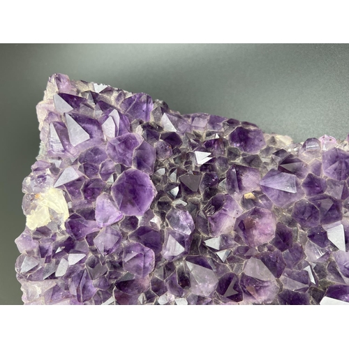 1267 - A large 3.7kg natural amethyst cluster geode with varying sized points. Approx. 23cm x 20cm at wides... 