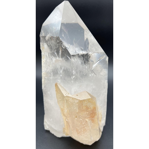 1270 - A heavy clear crystal quartz wand point with side clusters with orange/brown colour inclusions. Clea... 