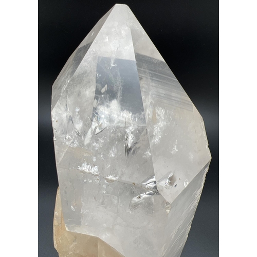 1270 - A heavy clear crystal quartz wand point with side clusters with orange/brown colour inclusions. Clea... 