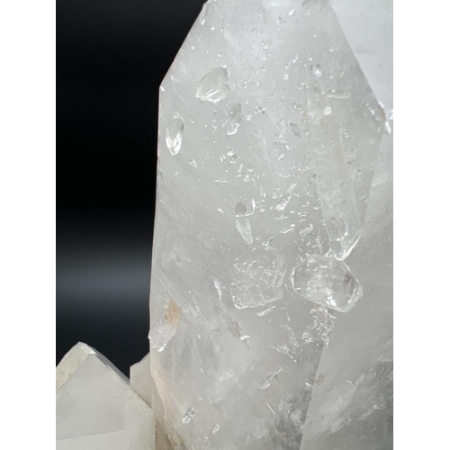 1271 - A large clear crystal quartz wand with multiple cluster detail. Natural white, black and orange colo... 